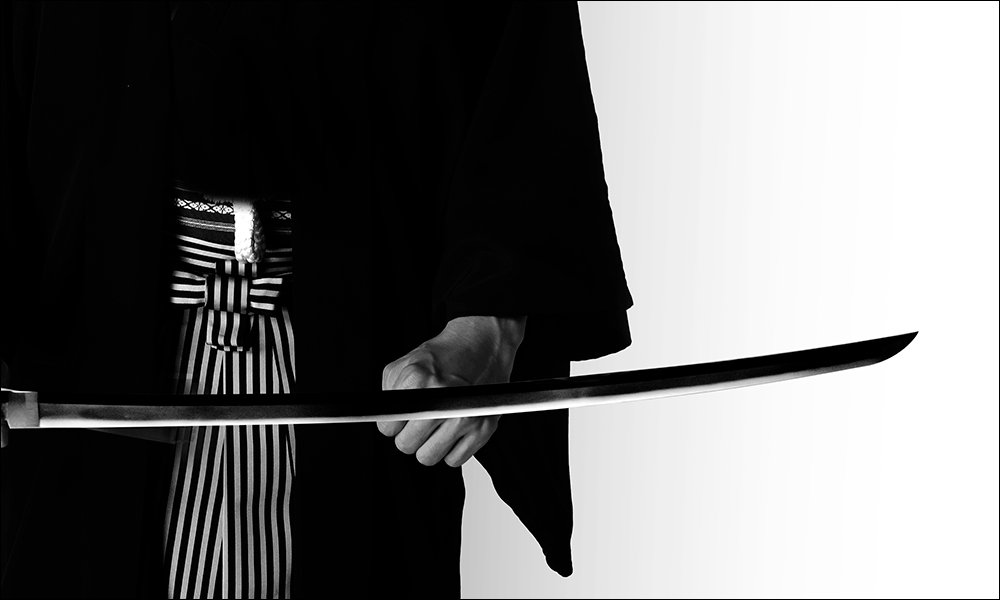 Samurai holding a naked Japanese sword Katana blade