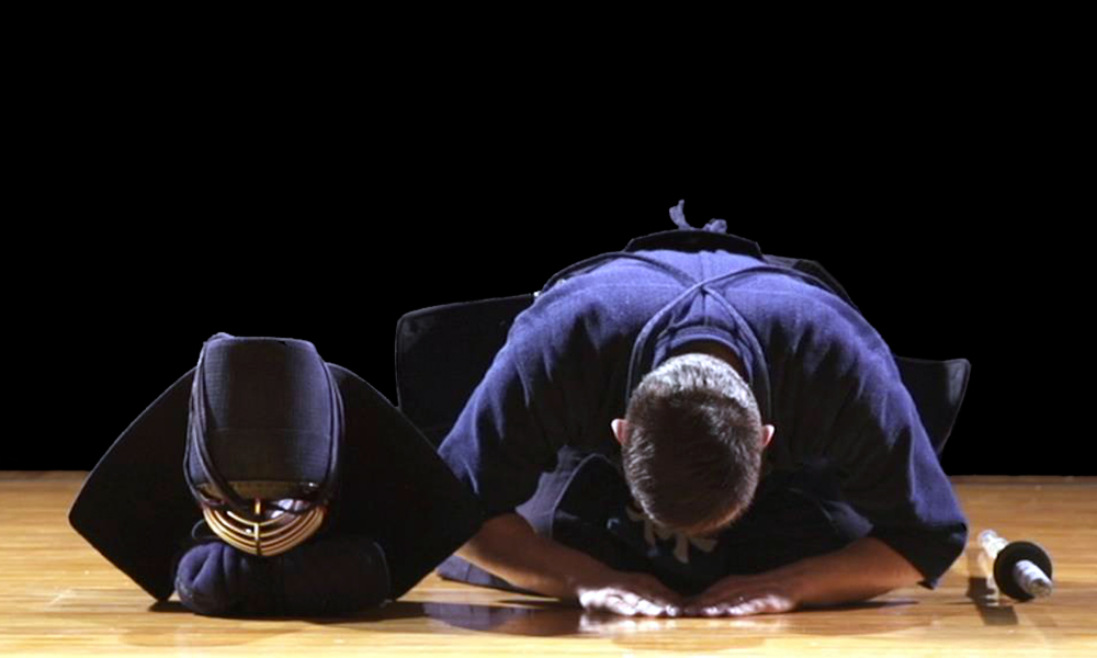 Image of a seated bowing Kendo player