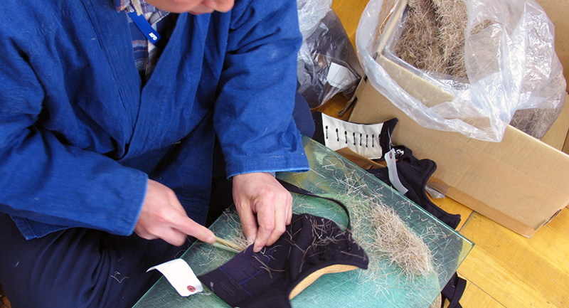 Kendo Bogu craftsman putting deer fur into Kote glove