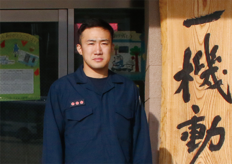 Kunitomo standing in front of Police Department